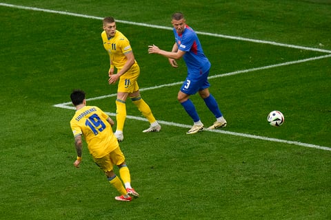 Mykola Shaparenko, left, scores Ukraine's opening goal